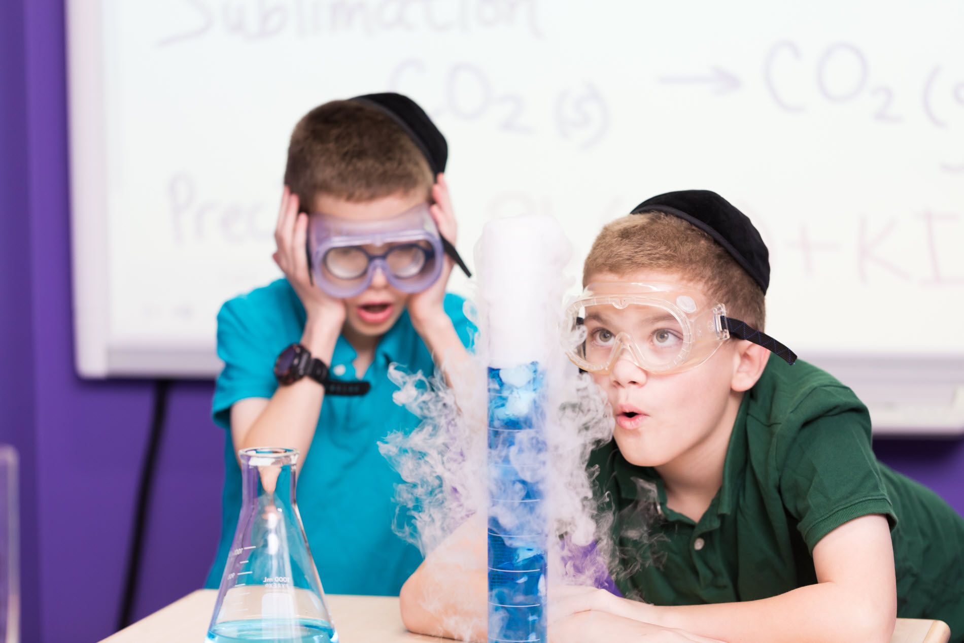 Two boys doing a chemistry experiment.